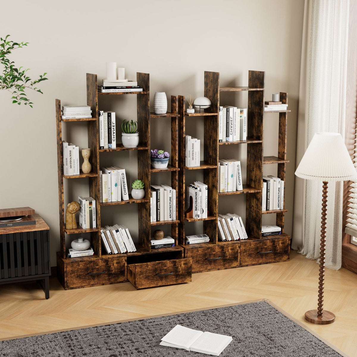 Wooden bookshelf with books and decor in a room with a lamp and plant.