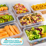 Clear plastic meal prep containers filled with colorful foods including pasta, sliced kiwi, melon, fruit granola, and salad, shown on a light background with a 'VERSATILE MEAL PREP CONTAINERS' badge.