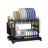 A black double-tier dish rack filled with blue, white, and gold ceramic plates, bowls, cups, and utensils, shown on a plain white background.
