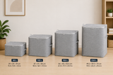 Four gray fabric storage bins in different sizes arranged from smallest to largest on a wooden floor, with capacity labels and dimensions overlaid: 30 L, 110 L, 150 L, and 220 L.