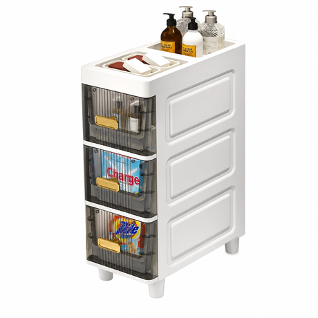 A white plastic storage organizer with three transparent drawers featuring gold handles and a top surface for toiletries, shown on a plain white background.