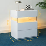 White nightstand with dimensions displayed, featuring a lamp and books on top.