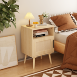 Wooden nightstand with books, lamp, and decor in a bedroom setting