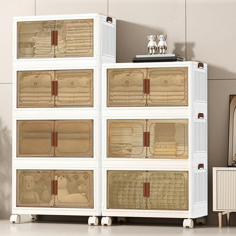 A set of six white plastic storage drawers with translucent beige-tinted doors and brown handles, shown filled with folded linens and toys in a clean indoor room setting.