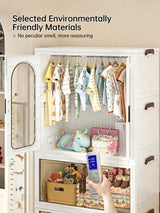 A white plastic baby storage closet with a glass door, shown open and filled with baby clothes, toys, and storage bins. A hand holding a remote control is visible in the foreground.