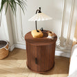 Round walnut-effect nightstand with a charging station, sliding door and open lower shelf