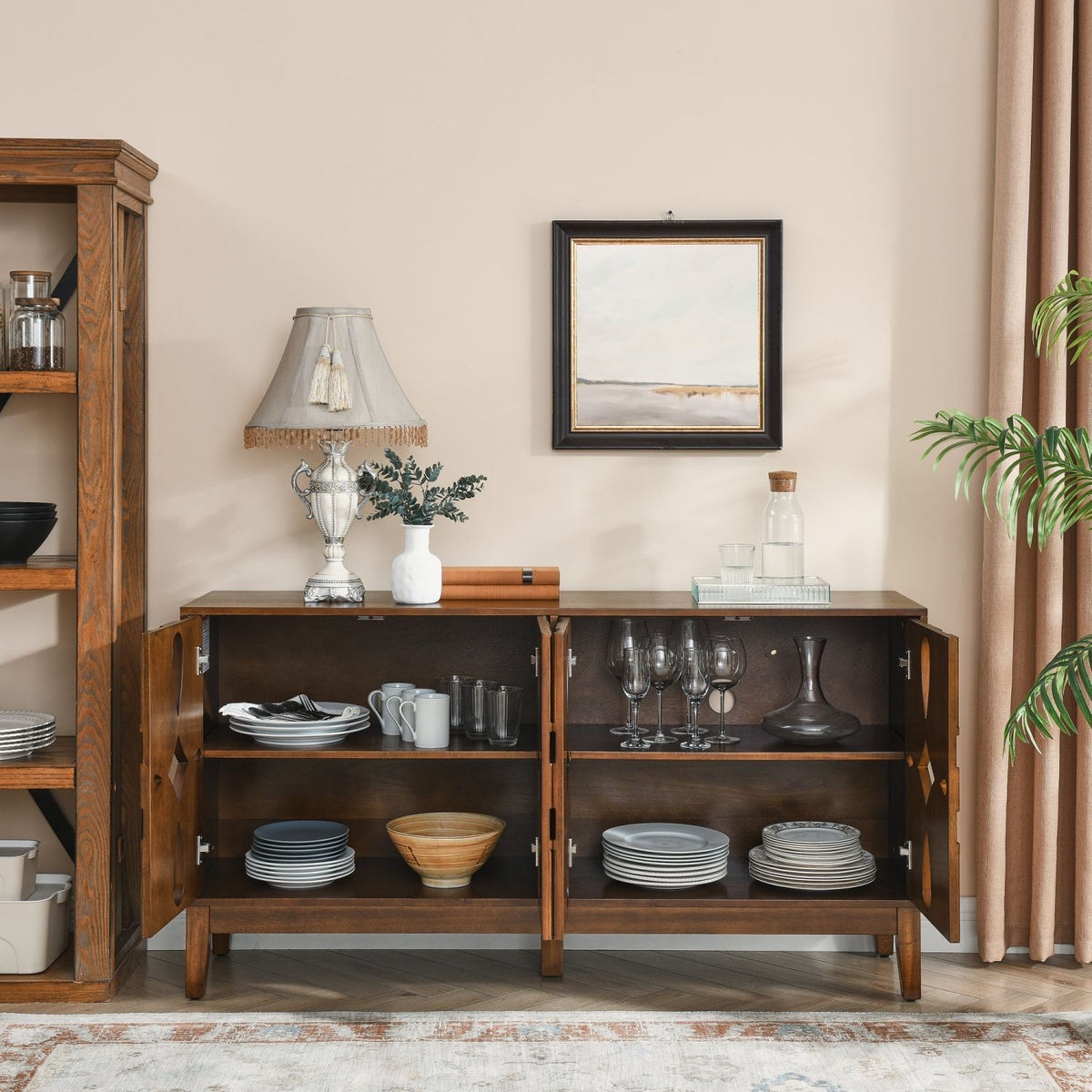 Wooden sideboard with open doors displaying tableware in a living room setting.