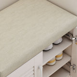 Shoe rack with beige cushioned top and white and yellow shoes underneath.