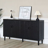Black sideboard with decorative patterns in a room with abstract art and a lamp.