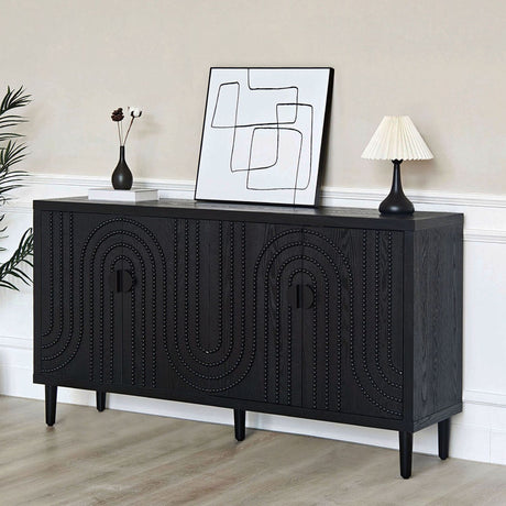 Black sideboard with decorative patterns in a room with abstract art and a lamp.