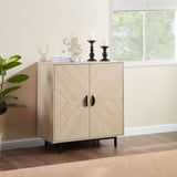 Light wood cabinet with black handles in a room with a window and plant.