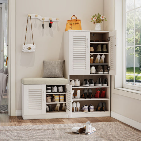 White shoe cabinet with open doors displaying shoes, a bench, and wall hooks with bags and a purse.