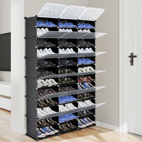 Black shoe rack with multiple shelves filled with shoes in a room.