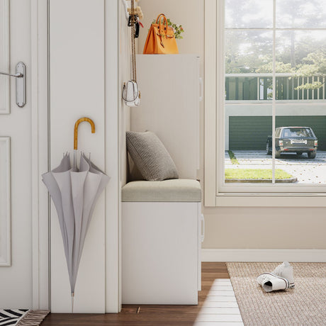 Small indoor sitting area with a bench, umbrella, and shoes near a window.