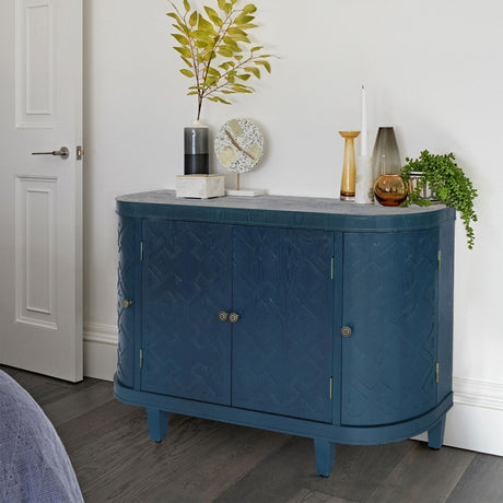 Blue sideboard with decorative items in a room setting
