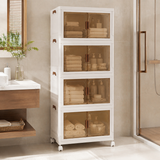A tall white bathroom storage cabinet with four glass-front doors and small wheels, shown in a clean bathroom setting next to a vanity and shower area.